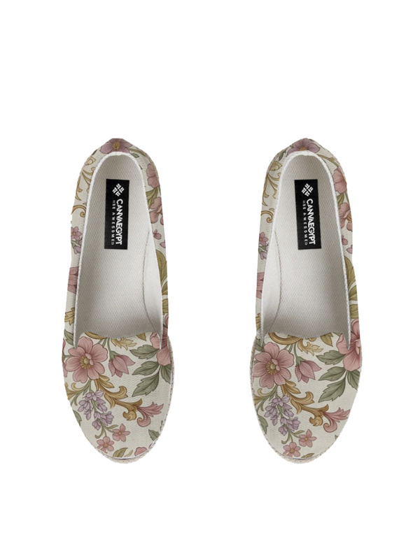 A pair of canvas Nook Espadrille shoes decorated with a vintage-inspired botanical pattern of pink flowers and green leaves on a cream background.
