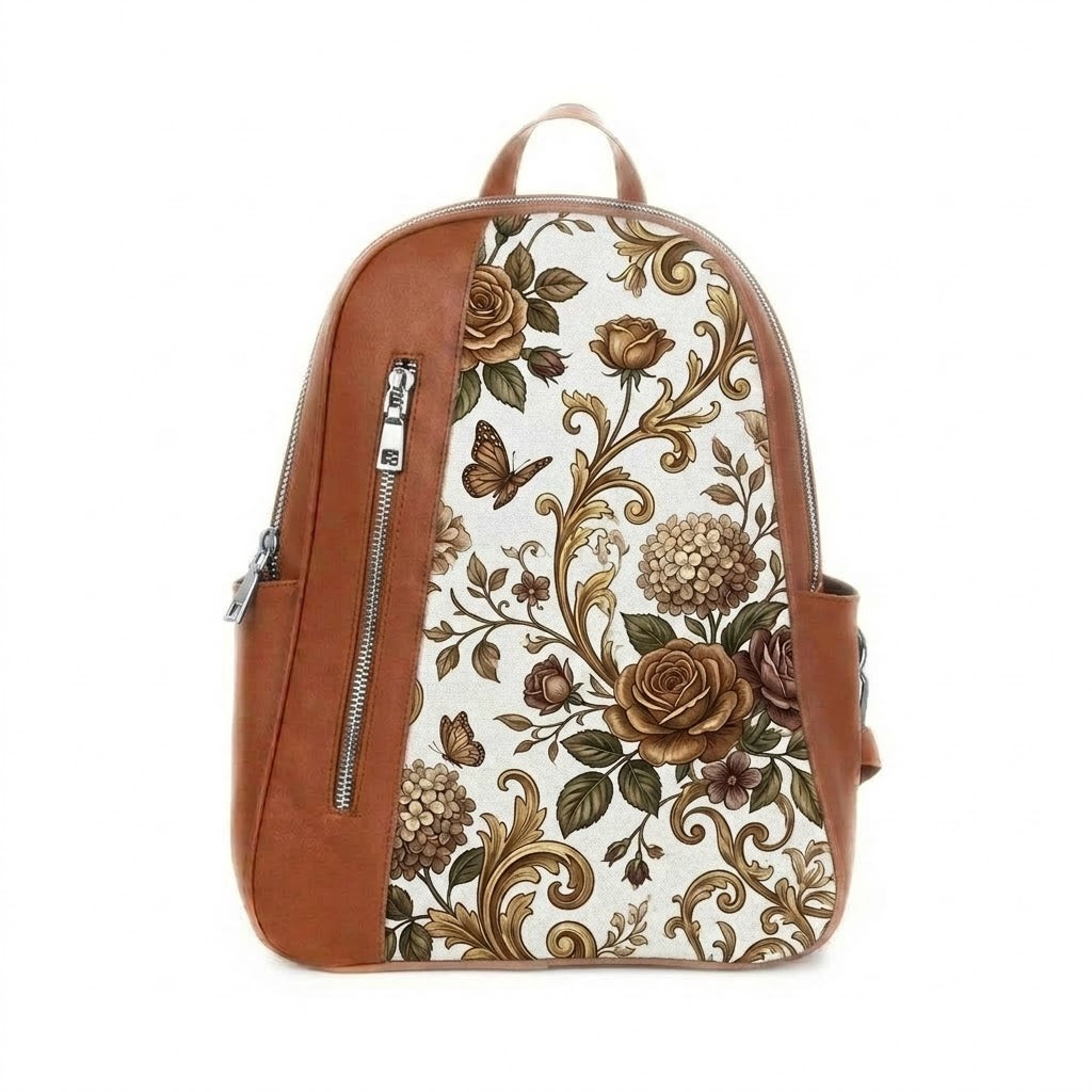 A Havana leather backpack featuring a white front canvas panel printed with a vintage pattern of golden-brown roses, ornate scrolls, and small butterflies.